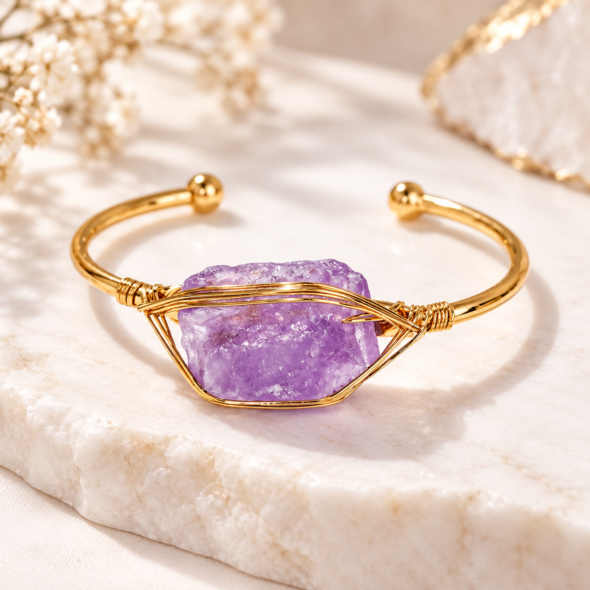 Women’s gold cuff bangle featuring a raw purple amethyst stone wrapped in delicate gold wire on a 304 stainless steel bracelet.